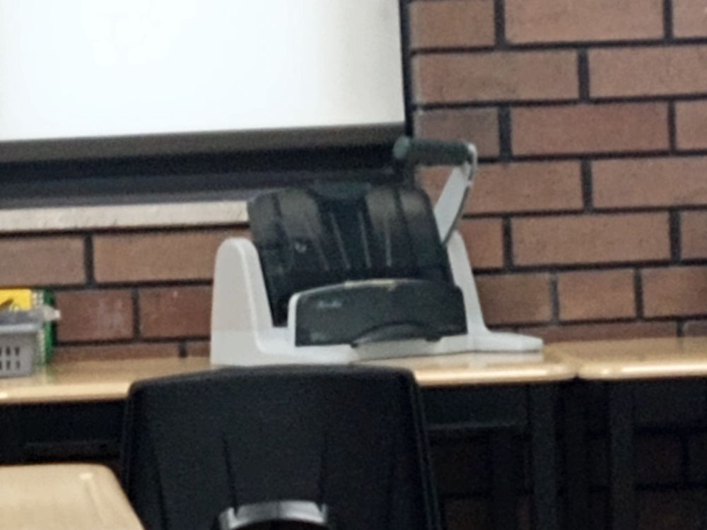 Black and grey hole puncher