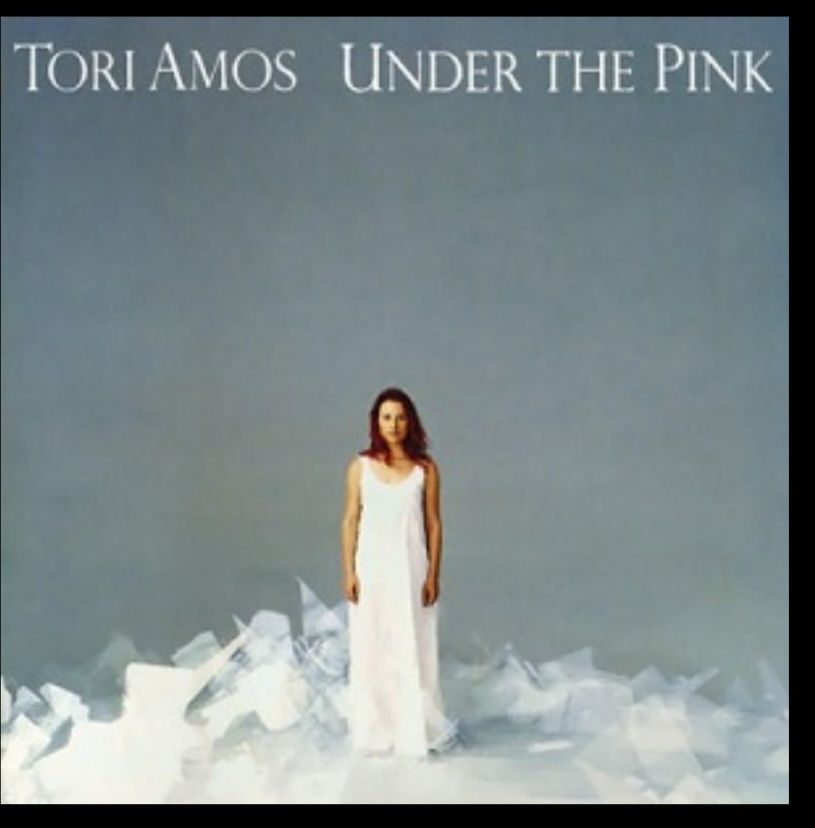 Tori Amos- Under the Pink
A redhead woman in a white dress on a grey background 