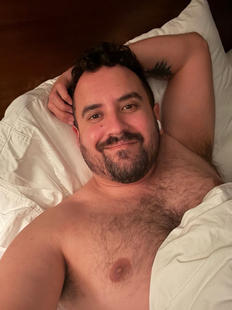 a pic of me in bed shirtless with my arm over my head. 