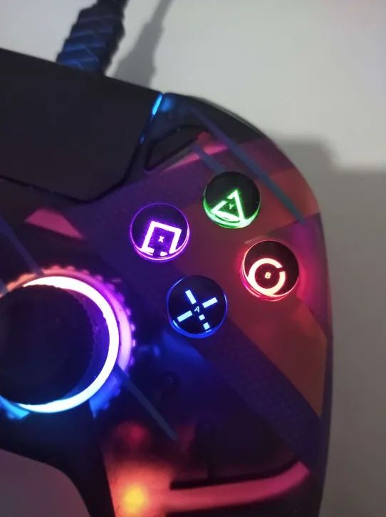 a photo of a joystick / gamepad / controller buttons on the right hand side.

The buttons show huge icons for Playstation layouts (from North-East-West-South button positions being, respectively; Triangle, Circle, Square, Cross / X); 

but inside those icons there are small letters for Xbox style button positions (being Y, B, X and A, on the same positions, going from North, East, West, South buttons.