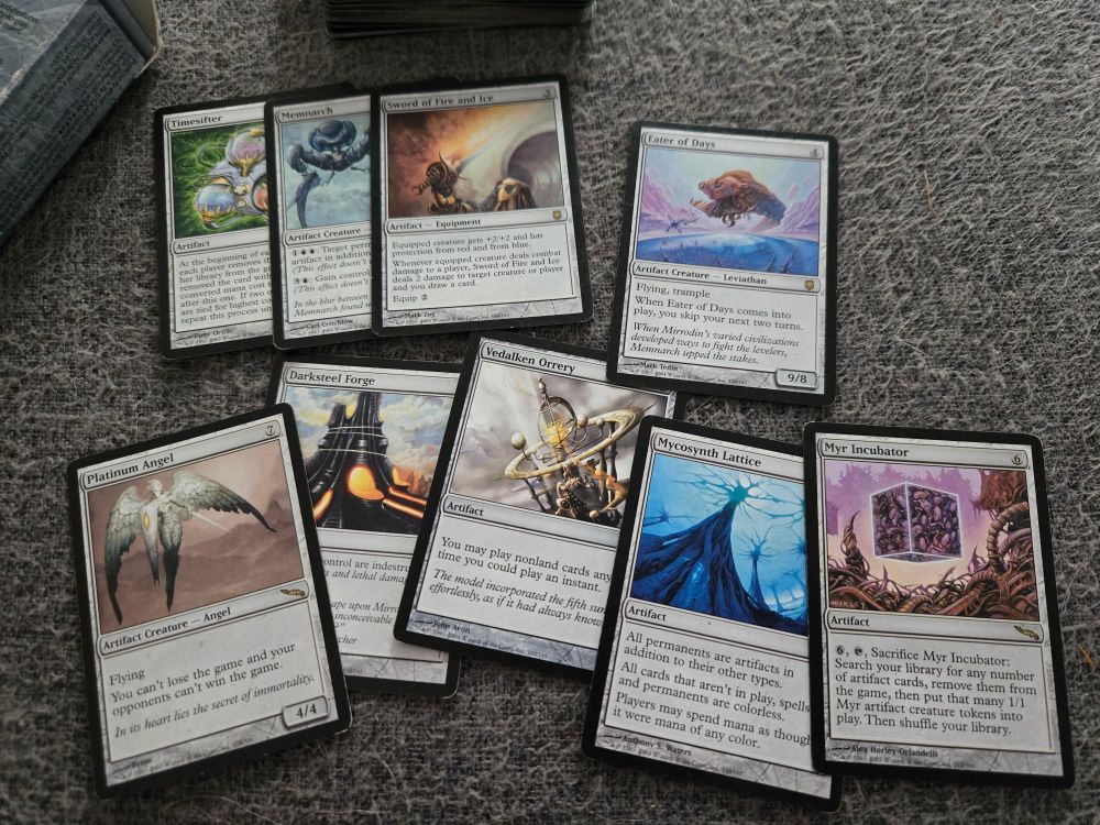 An assortment of rare artifact cards: Timesifter, Memnarch, Sword of Fire and Ice, Eater of Days, Platinum Angel, Darksteel Forge, Vedalken Orrery, Mycosynth Lattice , Myr Incubator 