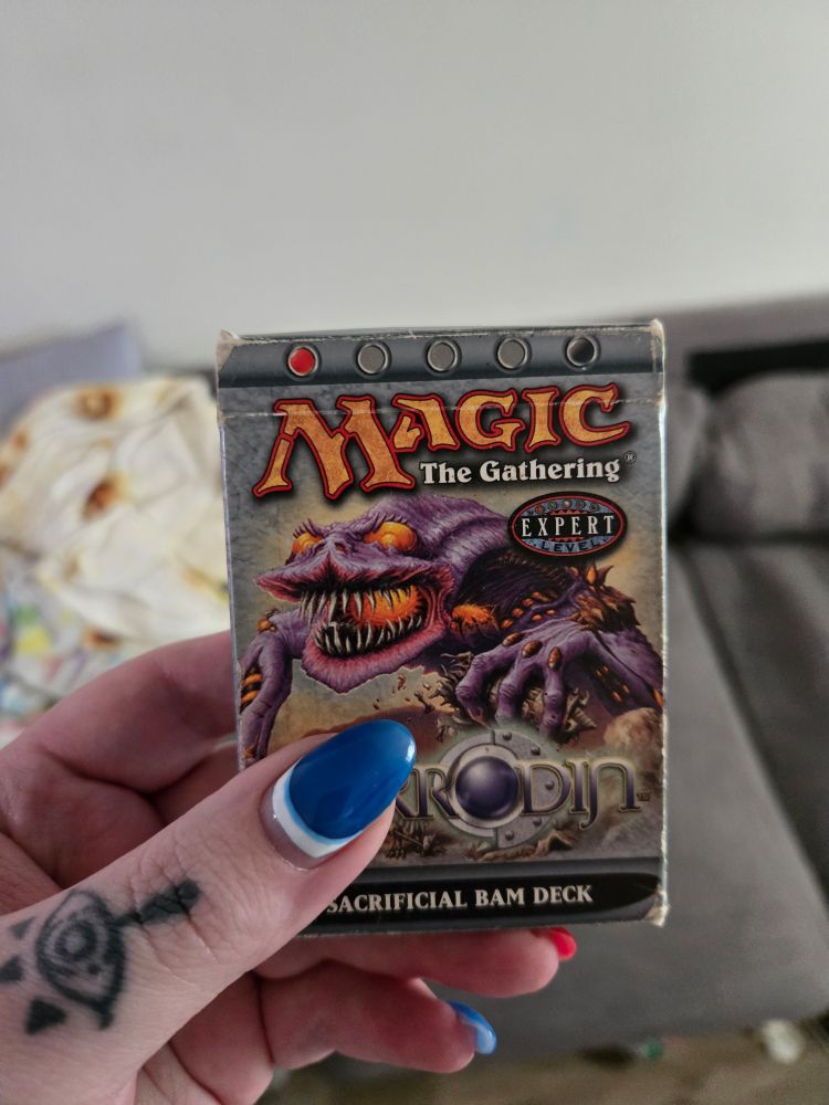 A photo of a very worn "sacrificial bam" mirrodin deck box