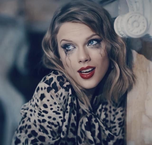 Taylor swift, a blond white woman with blue eyes and a bold red lip with smudged mascara from crying wearing cheetah print