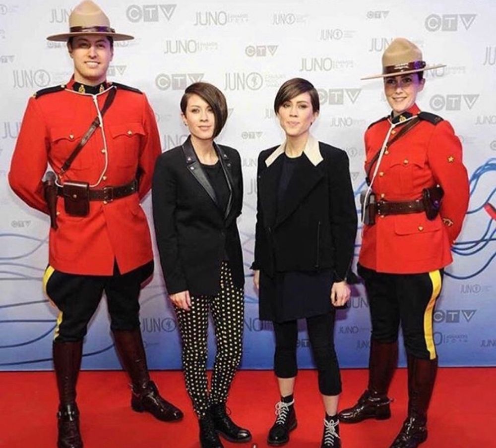Tegan and Sara flanked by two members of the Royal Canadian Mounted Police