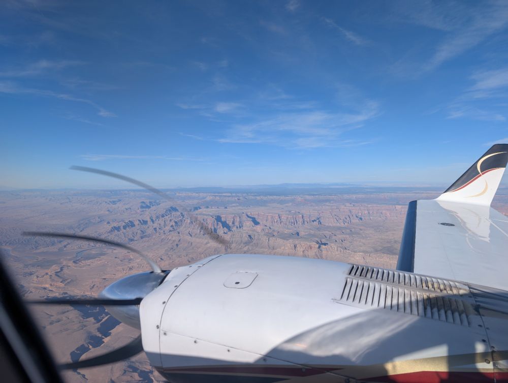 Airplane Wing and engine with the desert landscape in the distance