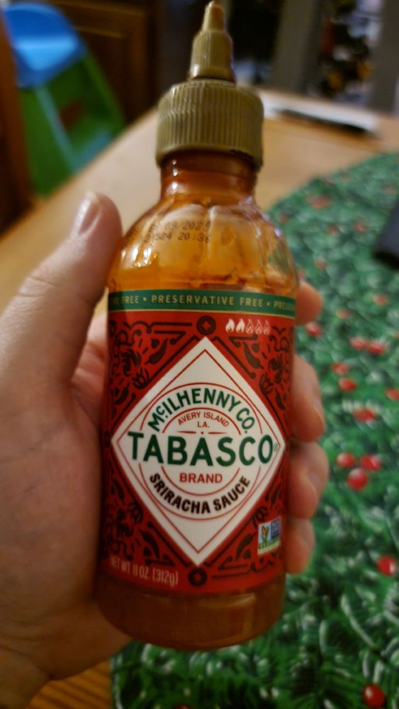 Mostly empty bottle of Tabasco brand Sriracha Sauce