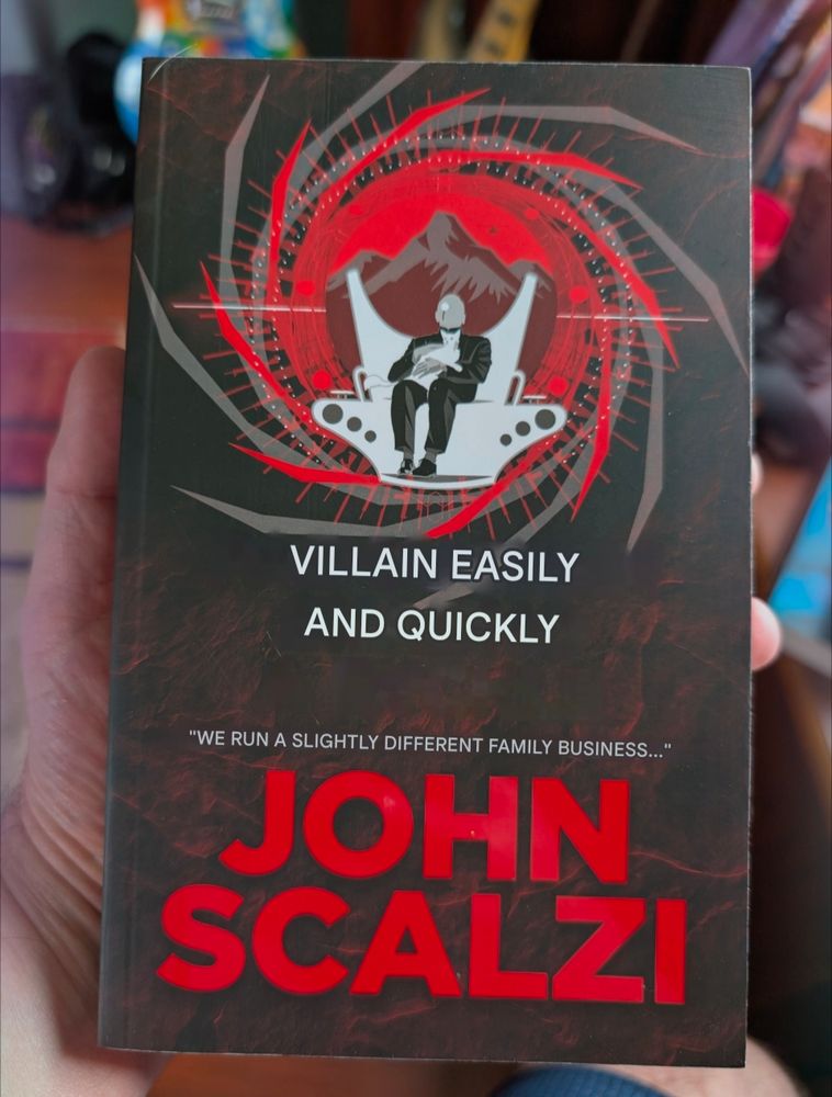 A Czech version of John Scalzi's Starter Villain with the Czech translated to English. 

It reads: 

Villain Easily and Quickly
"We run a slightly different family business..."
John Scalzi