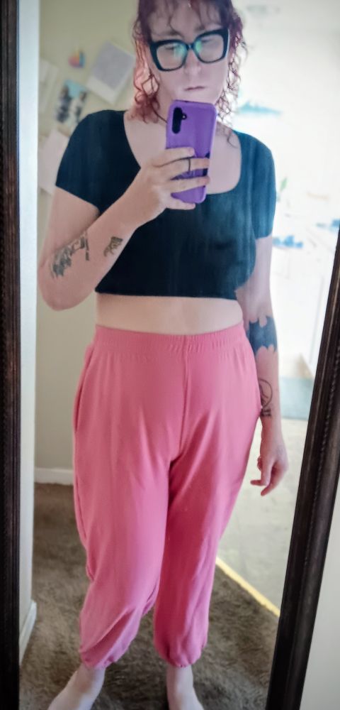 Ripley in a black fitted top, and pink sweat pants