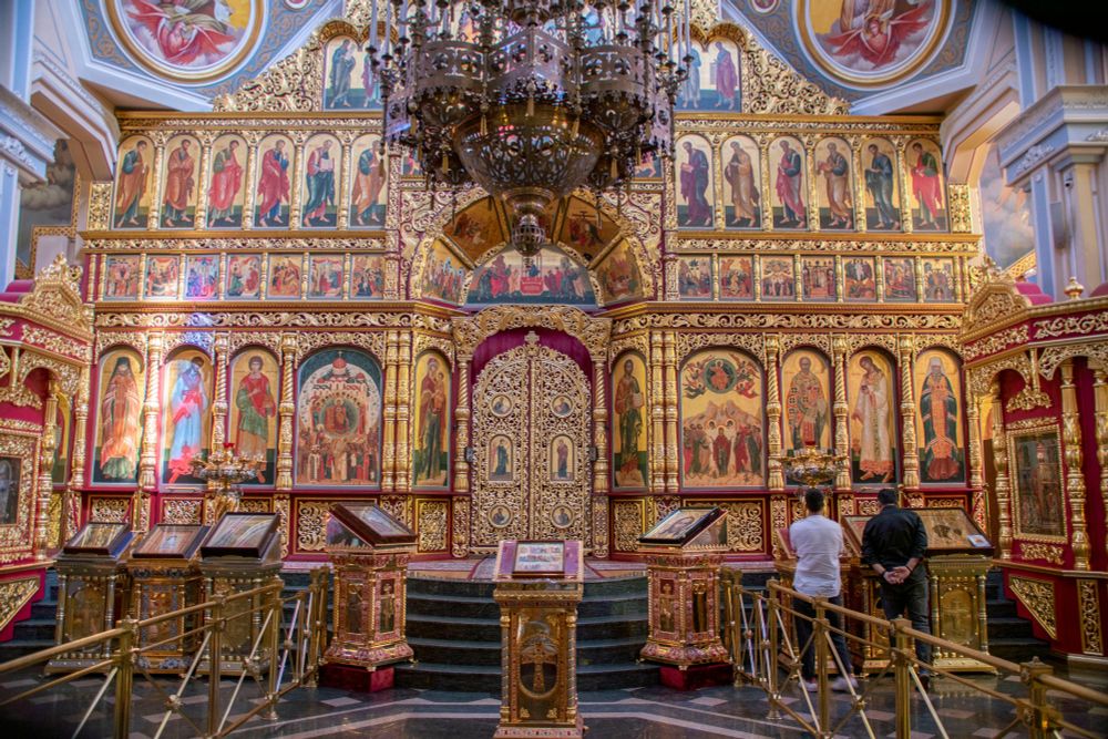 The ornate interior of Ascension Cathedral is dominated by the colour gold, and icons of various saints all around.