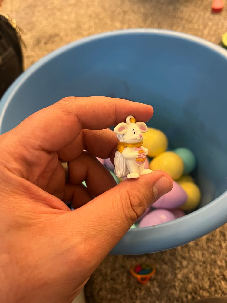 Gaze upon his end, may it give ye pause when considerin’ a life of crime. A paratrooper bunny with a rubber band around his parachute and neck over a background of Easter eggs.