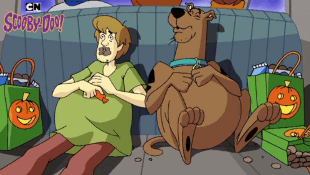 a scooby doo cartoon shows shaggy and scooby doo sitting on the ground