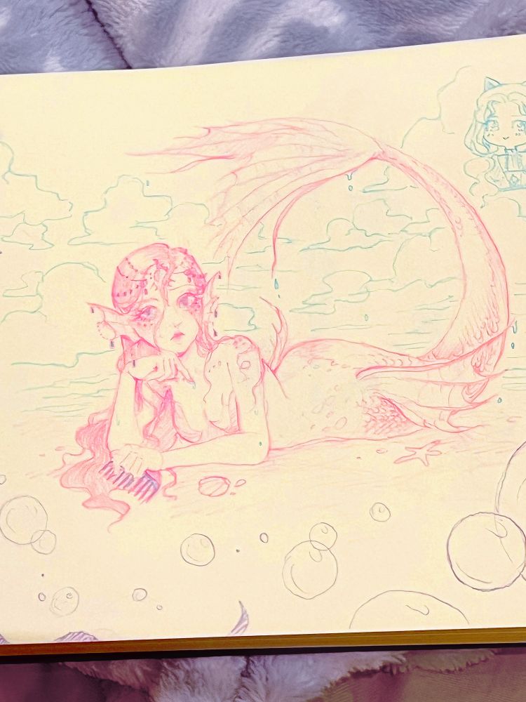 Photo of a sketch in pink and blue pencil of a mermaid lying on her stomach with her tail curling up above her. Her hair is wet and wavy, sticking to her face and skin, and she has ornate head and ear jewellery. She has an unimpressed expression and holds a comb in her hand. The photo's saturation is jacked up a lot to enhance the pink tones of the sketch.