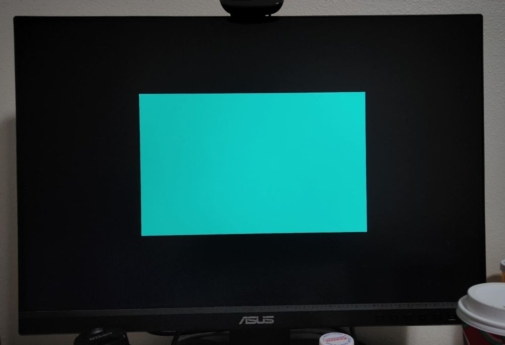 a rectangle drawn in the center of a monitor. it fills half the width and half the height and exists as a nice turquoise colour.
