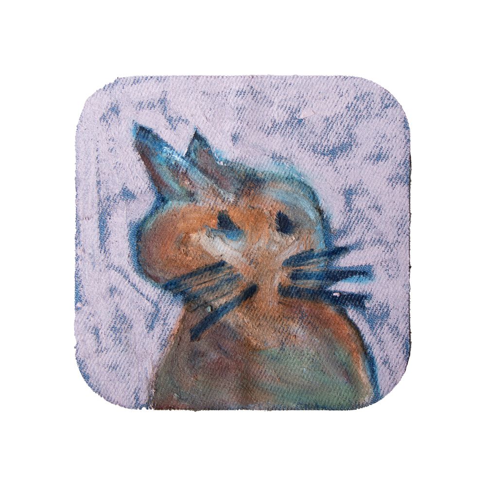 A painting done on an iron-on patch. A loosely shaped, brown, blue and orange animal. Two pointy ears on the top left of the head, deep blue eyes and whiskers, and a pink background with blue coming through the loosely done oil paint. 