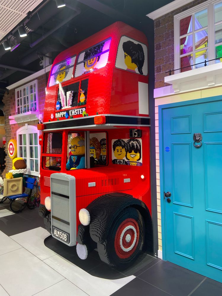 The front part of a London bus, made entirely in Lego located with the London Lego store. The route information displays an Easter message.