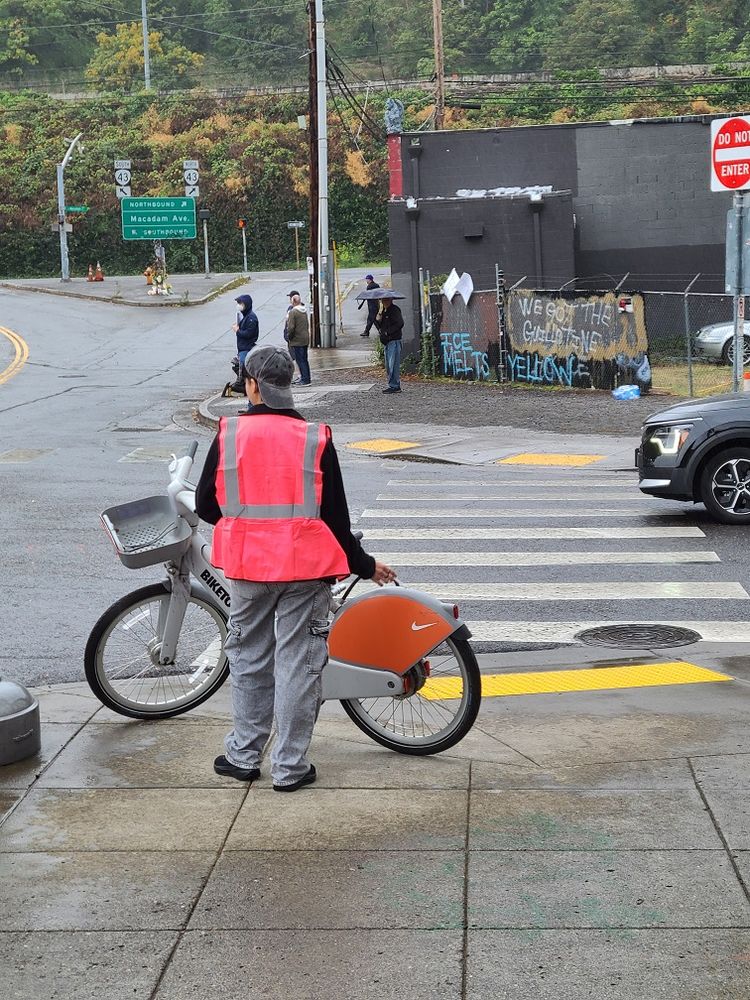 the opposite side of the street, I count 5 people but there's maybe a dozen behind me and to my right
