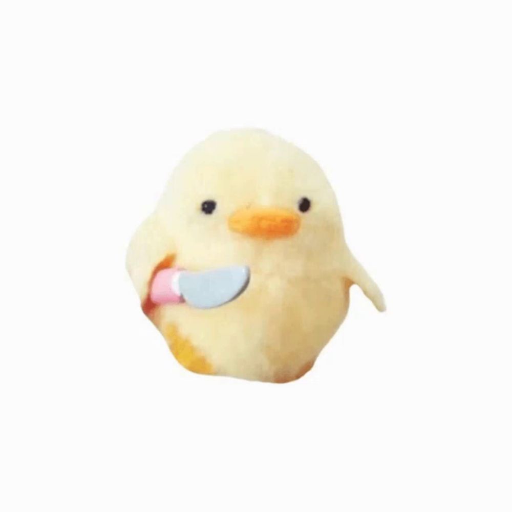 a stuffed duck holds a knife in its mouth