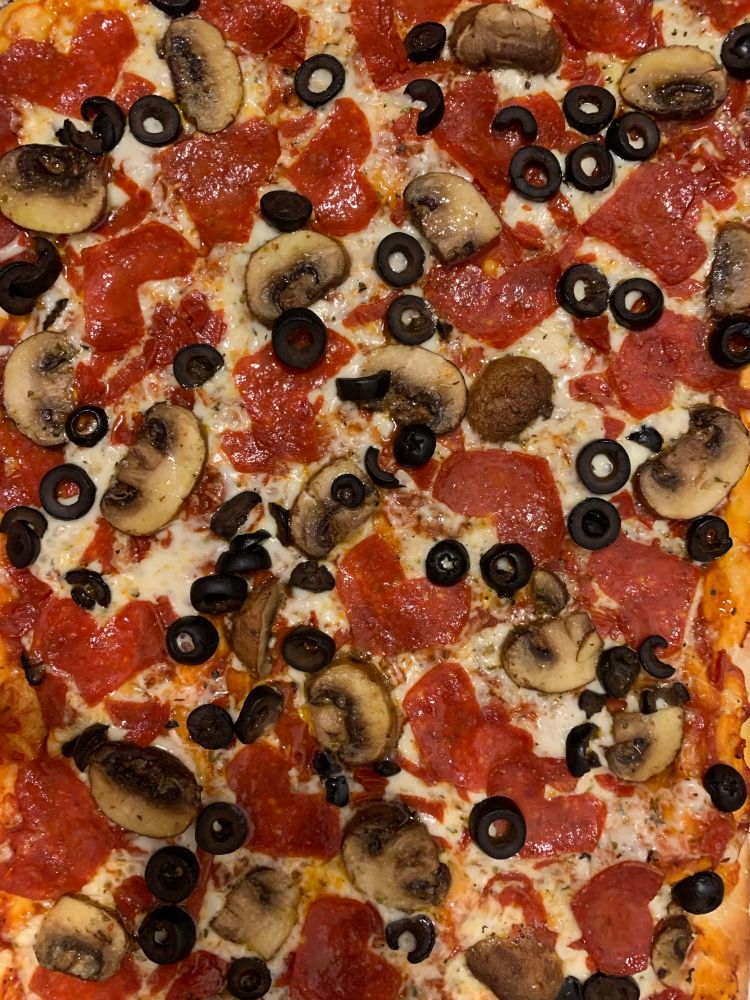 Homemade pizza with mushrooms, olives, and heart shaped pepperonis. Ronihearts? 