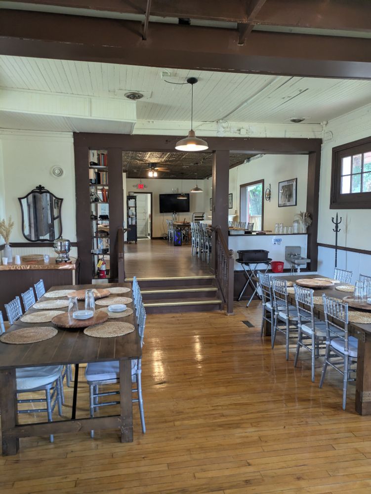 The restored wood floors inside the shop with restaurant-style seating at large tables