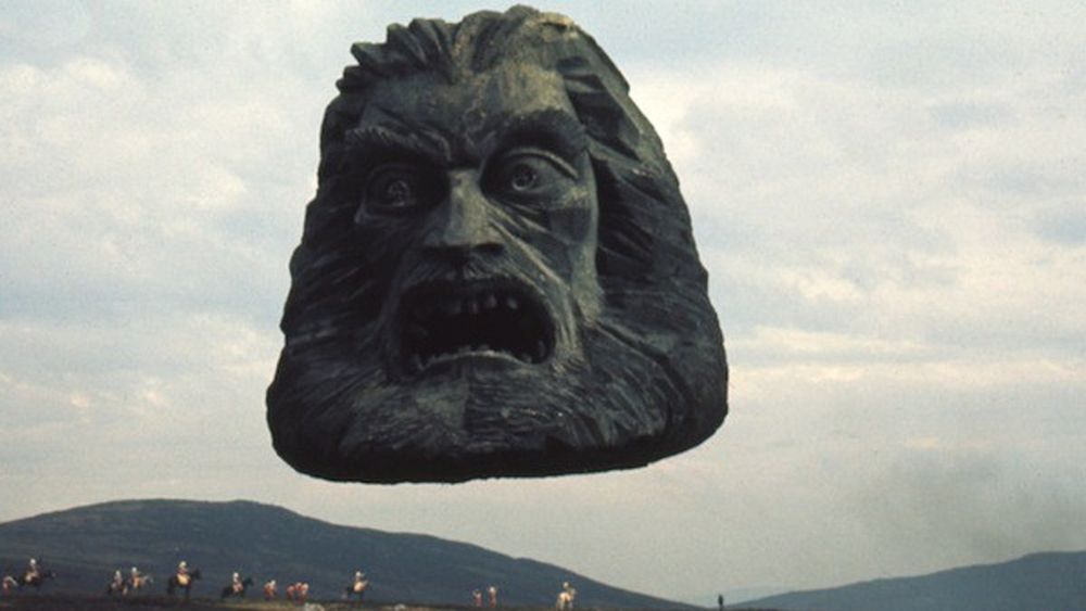 A still from the movie Zardoz showing a floating stone head