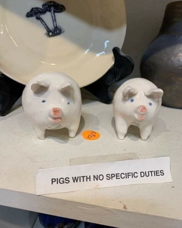 Pigs! With no specific duties. Little porcelain cuties with a sign.