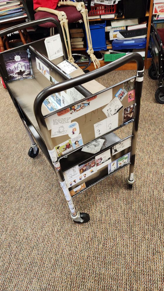 Library cart with comics on it. 
