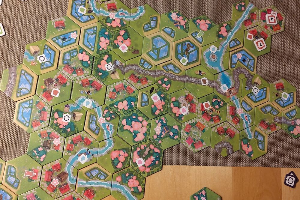 Hexagon tiles from the game "Dorfromantik Sakura" forming a beautiful Japanese village landscape