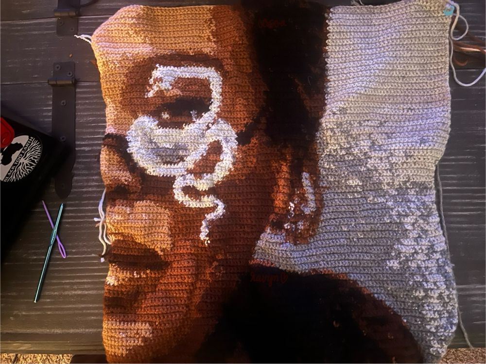 a crochet tapestry made by @cocoafairie on tiktok! is a photo that is on the back of beyoncé’s white limited edition beyincé vinyl.