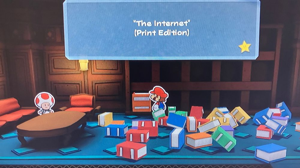 Mario inspecting a ridiculously thick book entitled “The Internet (Print Edition).”