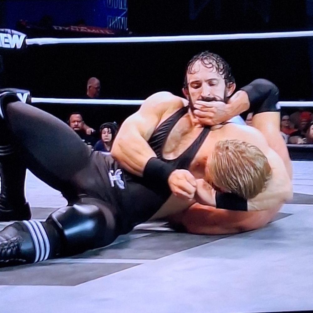 Pac with Orange Cassidy in a headlock