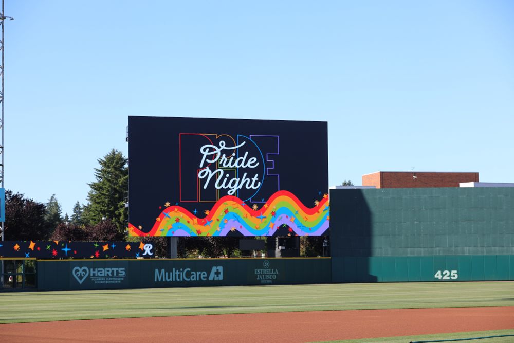 A photo of the video board at Cheney Stadium displaying Pride Night artwork