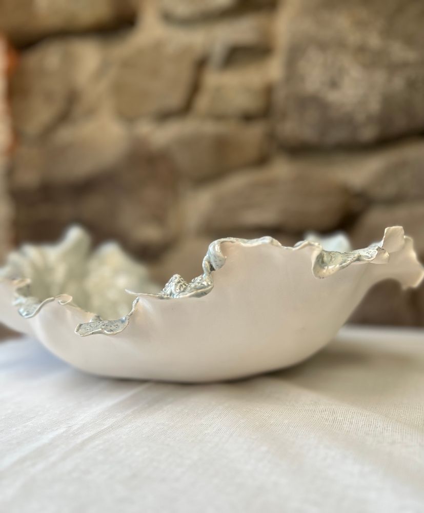 Re-fired, with glaze on the textured side, and only a smoothed, almost ‘soft’ underside