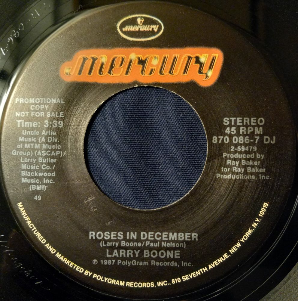 An image of the actual 45 RPM label on Mercury Records of "Roses in December", by Larry Boone from 1987. (Same on Both Sides)