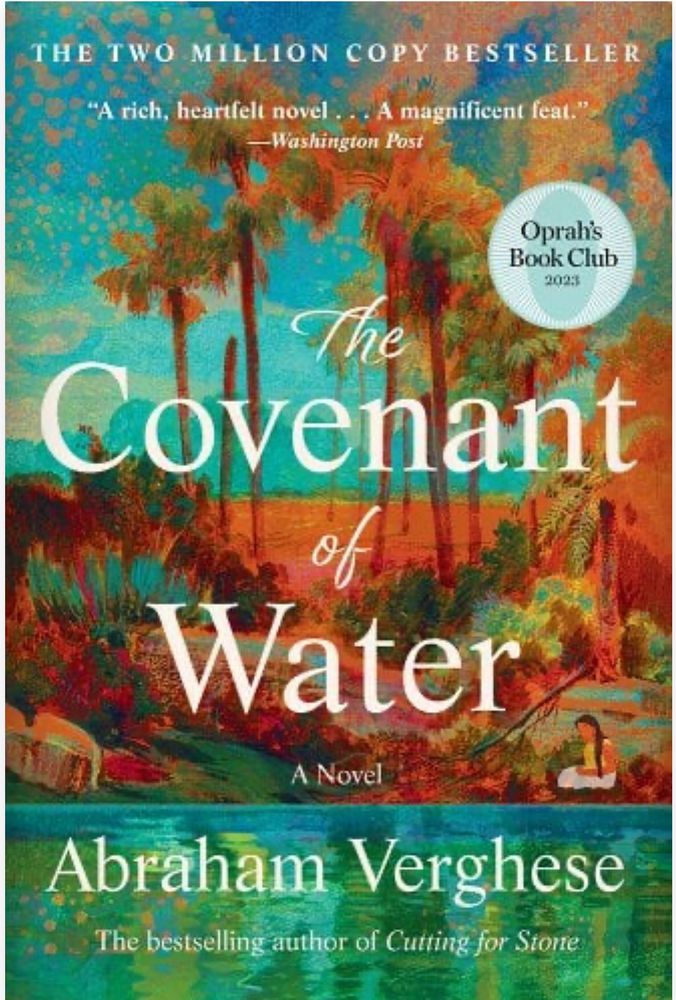 Cover of, The Covenant of Water, by Abraham Verghese.  Female sitting at the bank of a lake. Tall grass and trees in background.