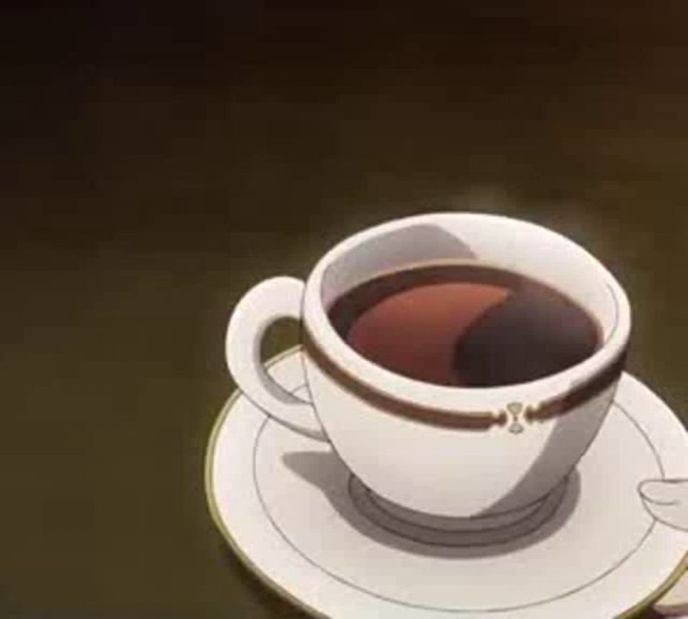 there is a cup of coffee on a saucer on a table .