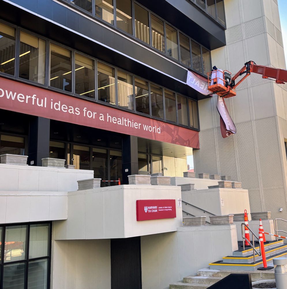 Banner at the Harvard Chan School of Public Health being taken down (ominously)