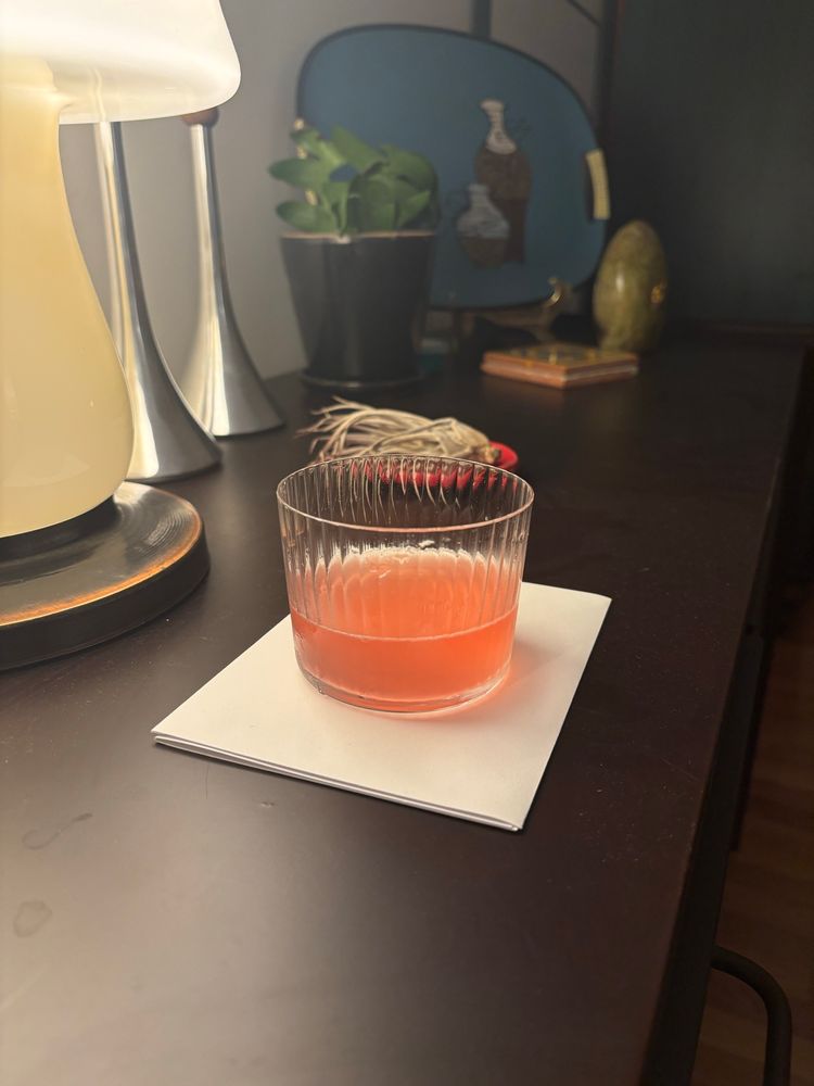 Small tasting glass with a pinkish cocktail, missing a garnish because I’m being lazy.