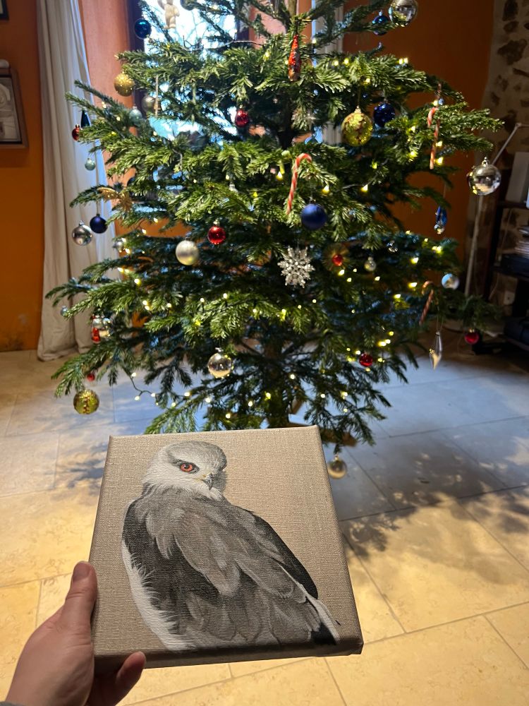 Xmas tree and painting of white and black raptor 
