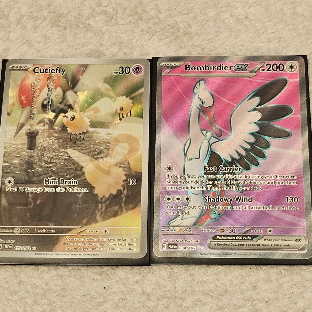 Two pokemon cards showing a Full Art Cutiefly and an Ultra Rare Bombirdier EX card. I love them

