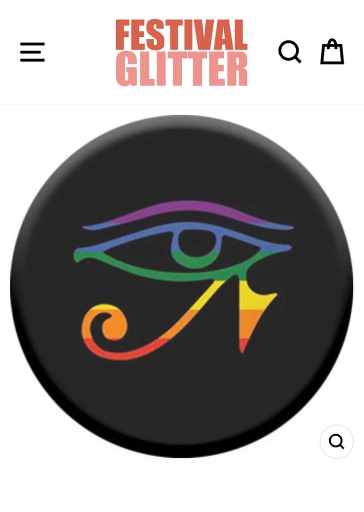 A round black pin badge on a white background. The badge has the eye of Horus in rainbow colours. At the top of the page it says Festival Glitter in orange and peach. 

