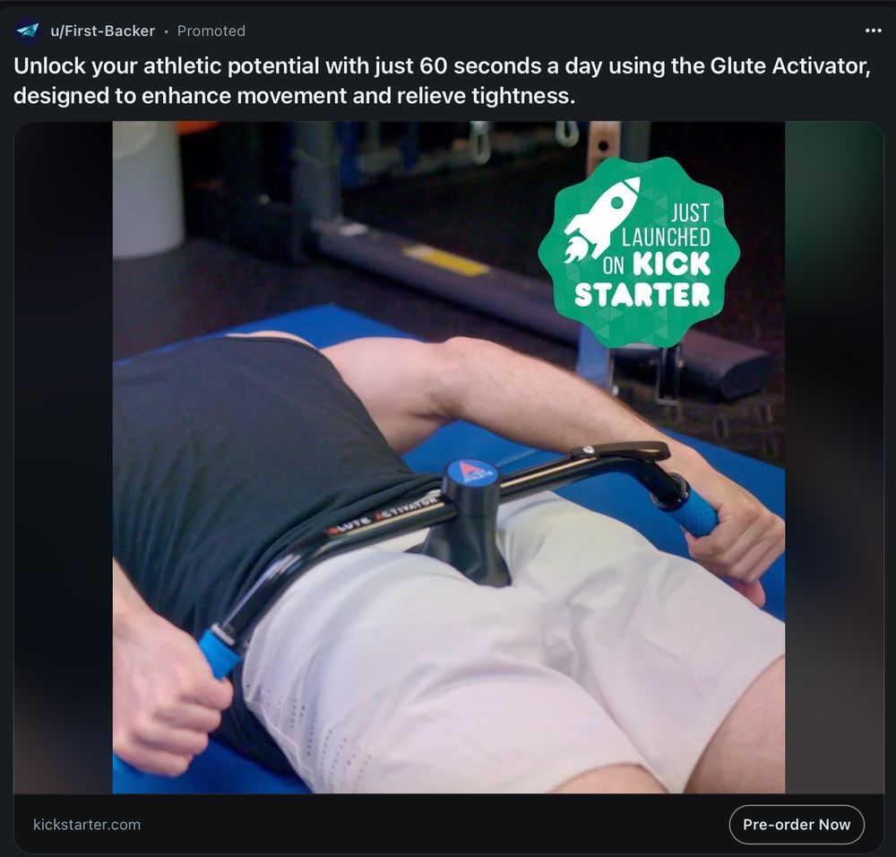 A picture of what appears to be a man, lying down on a gym mat. Facing downwards. I think. Because all of them is visible except their head, which is oddly missing. The product being sold is some kind of t-shaped metal bar for workouts, which they're holding onto at both ends. The t-shape in the middle appears to be sitting very much in the crack of their butt. It's not obvious how far in it goes.