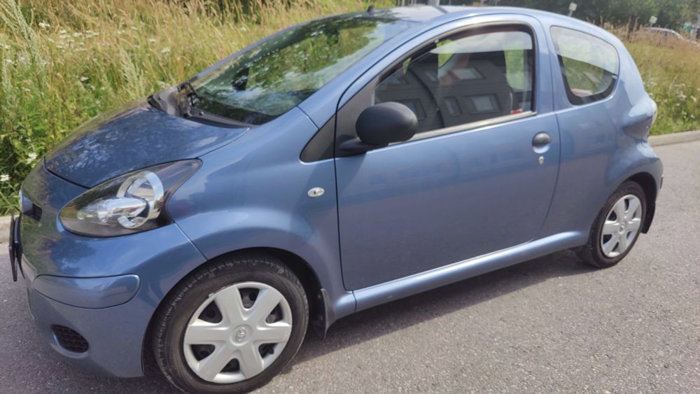 Photo of a blue 2010 model Toyota Aygo from the driver's side.