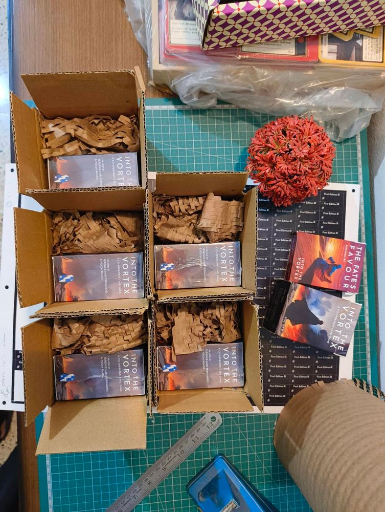 A photograph of 5 Into the Vortex boxes in shipping boxes with packing material