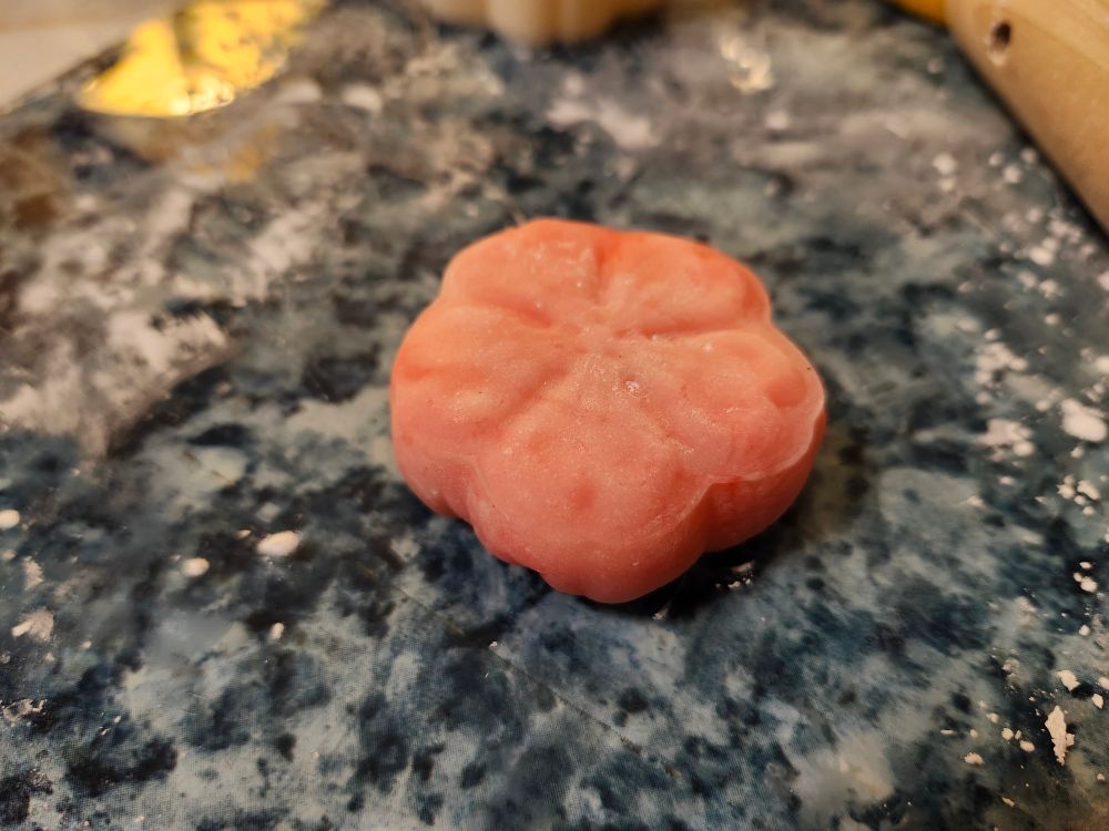 A pink cherry blossom-shaped mochi cake