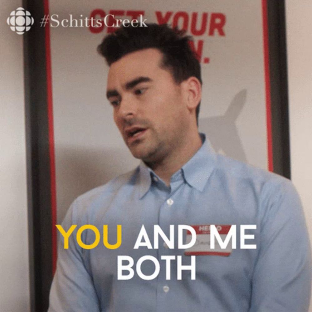 a man says you and me both in front of a poster