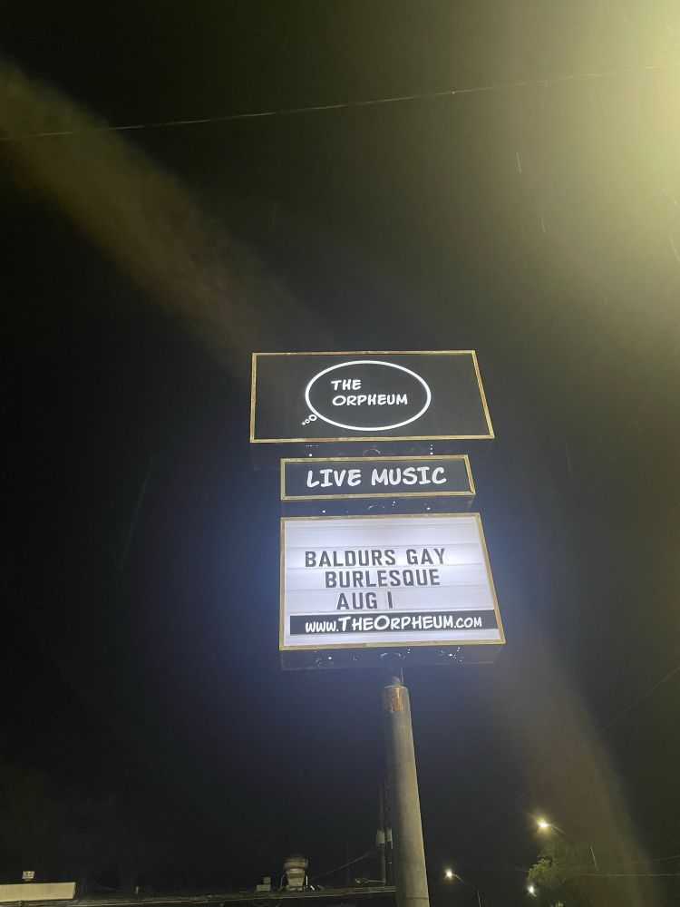 A sign that says THE ORPHEUM LIVE MUSIC: BALDURS GAY BURLESQUE AUG 1