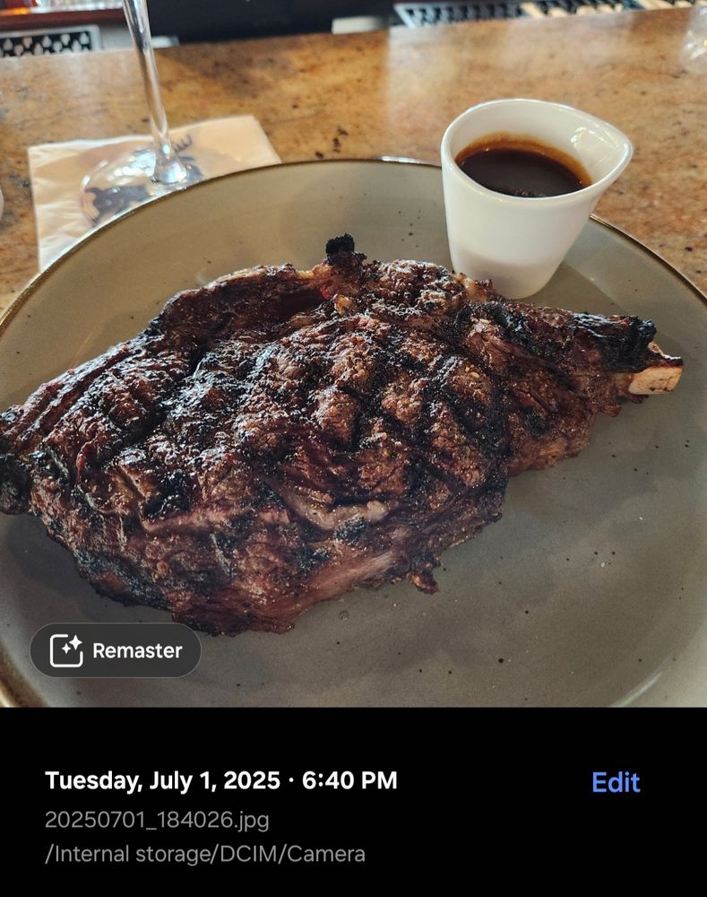 A large steak on a plate with a small cup of sauce on the side, timestamped six forty pm.