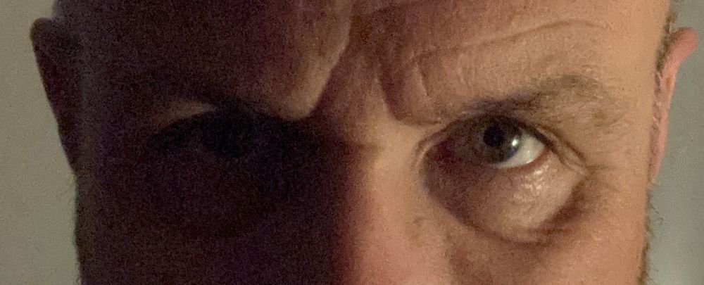 A man’s eyes looking directly at the camera. 