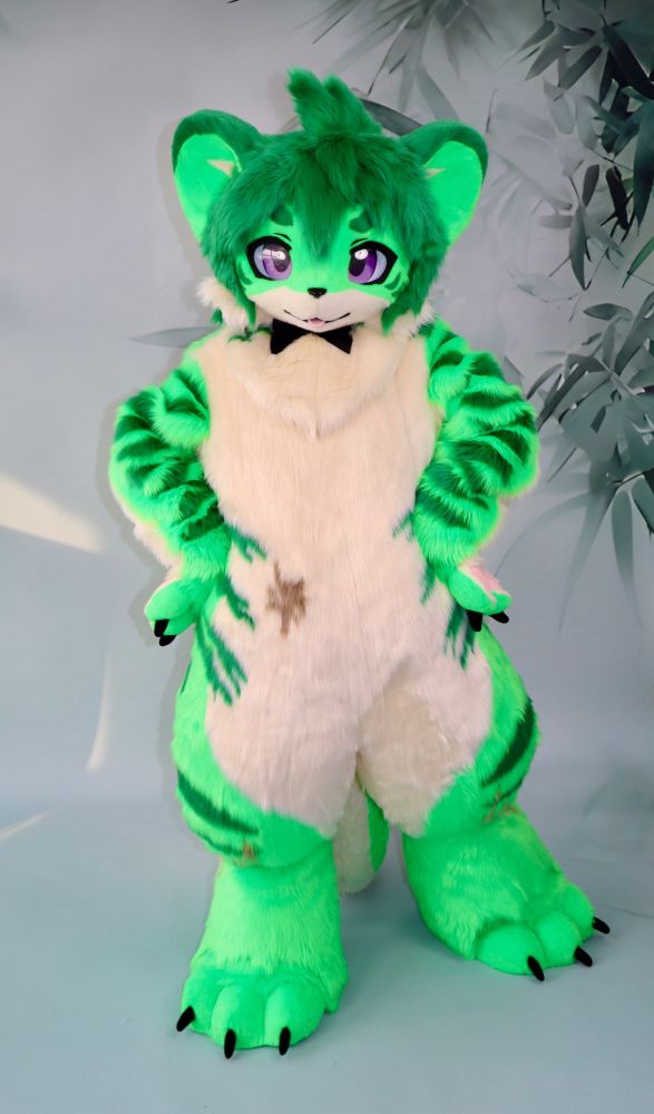 The same suit is now standing with one foot forward and hands on its hips 