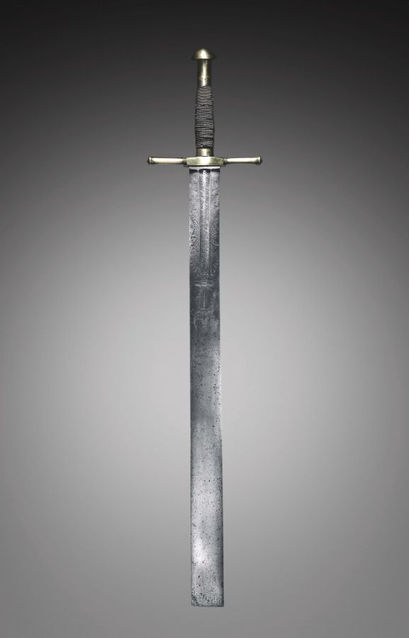 A silver sword with a simple silver hilt wrapped in gray string or leather. The sword has a square tip, marking it as an executioner's sword.